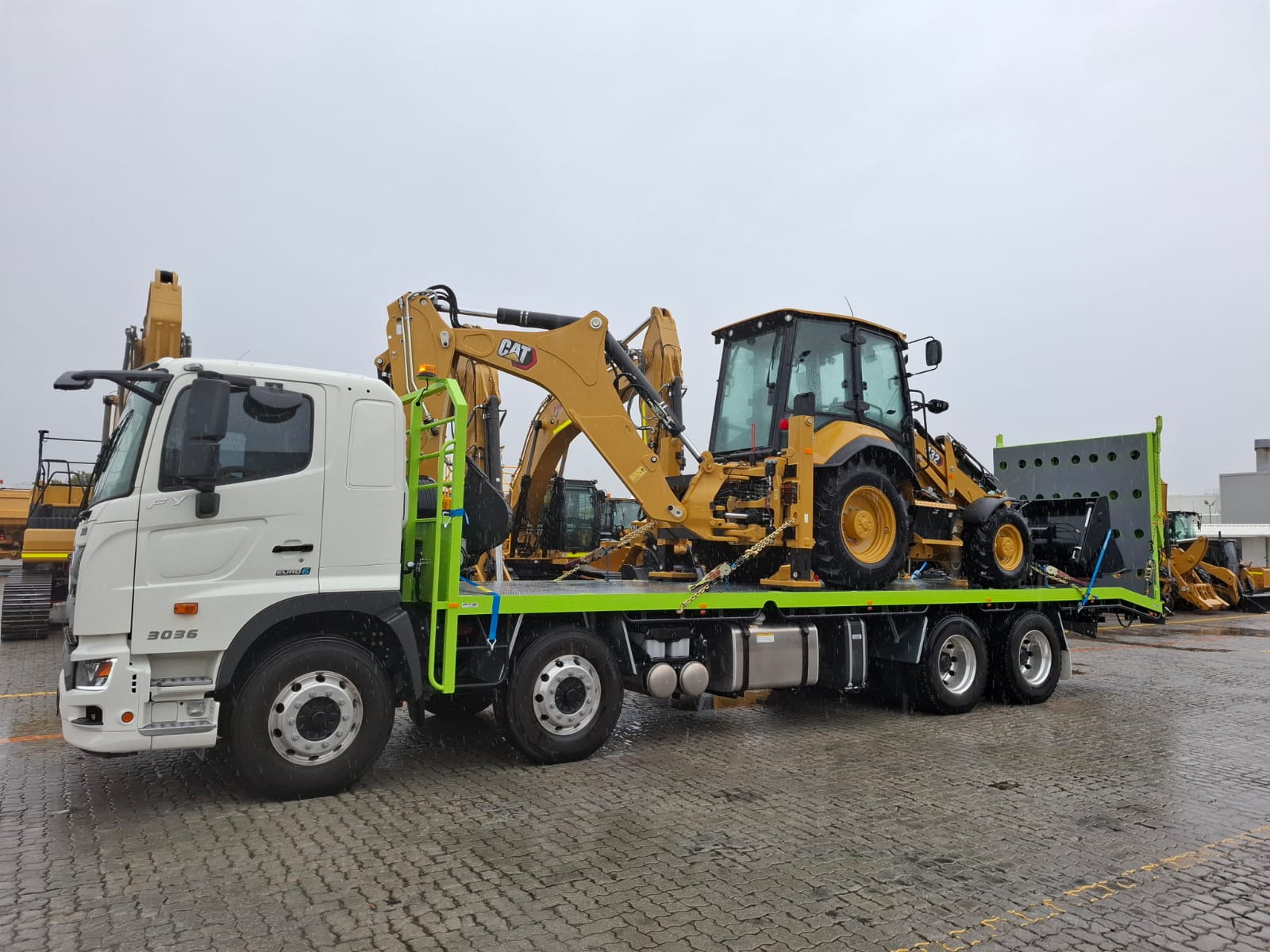 CAT backhoe loader transport in wet conditions